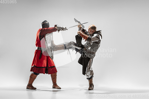 Image of Brave armored knights fighting isolated on white studio background