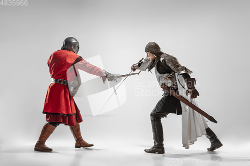 Image of Brave armored knights fighting isolated on white studio background