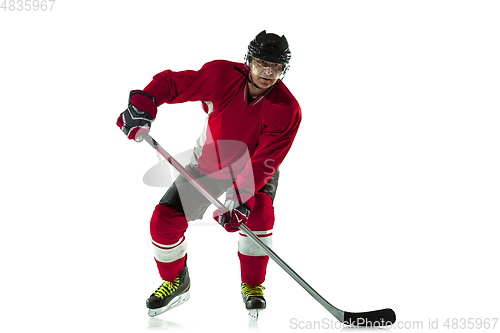 Image of Male hockey player with the stick on ice court and white background