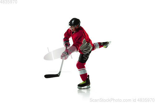 Image of Male hockey player with the stick on ice court and white background