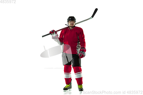 Image of Male hockey player with the stick on ice court and white background