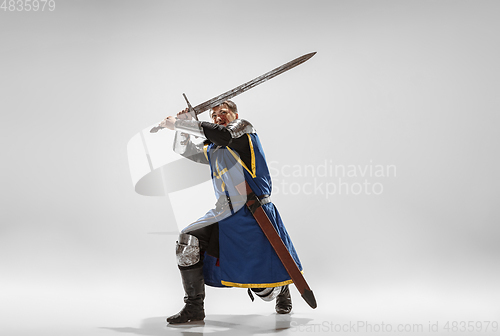 Image of Brave armored knight fighting isolated on white studio background