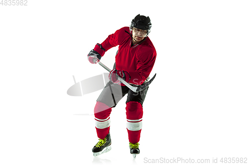 Image of Male hockey player with the stick on ice court and white background