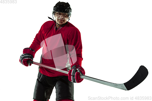 Image of Male hockey player with the stick on ice court and white background