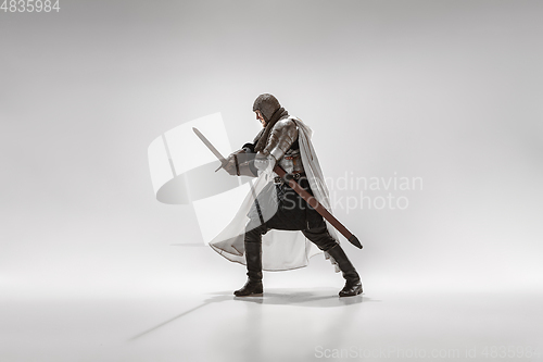 Image of Brave armored knight fighting isolated on white studio background