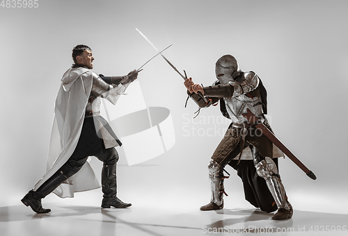 Image of Brave armored knights fighting isolated on white studio background