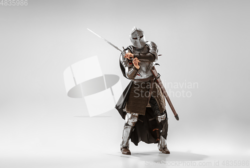 Image of Brave armored knight fighting isolated on white studio background