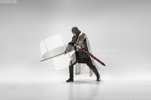 Image of Brave armored knight fighting isolated on white studio background