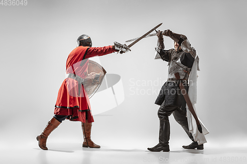 Image of Brave armored knights fighting isolated on white studio background