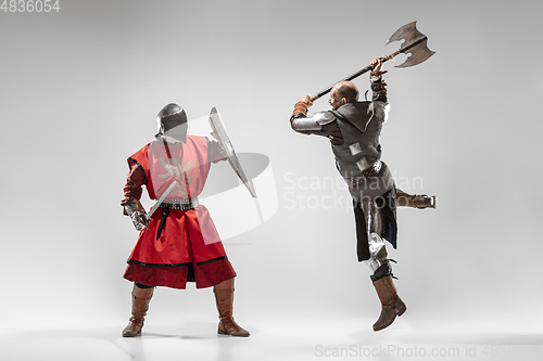 Image of Brave armored knights fighting isolated on white studio background