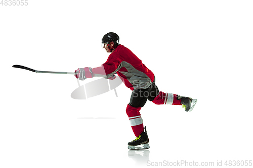 Image of Male hockey player with the stick on ice court and white background