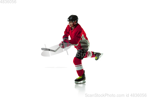 Image of Male hockey player with the stick on ice court and white background