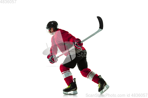 Image of Male hockey player with the stick on ice court and white background