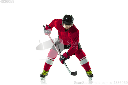 Image of Male hockey player with the stick on ice court and white background