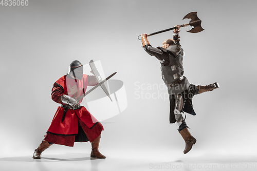 Image of Brave armored knights fighting isolated on white studio background