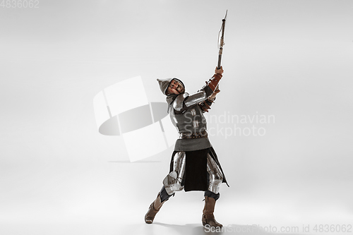 Image of Brave armored knight fighting isolated on white studio background