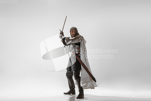 Image of Brave armored knight fighting isolated on white studio background