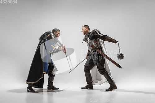 Image of Brave armored knights fighting isolated on white studio background