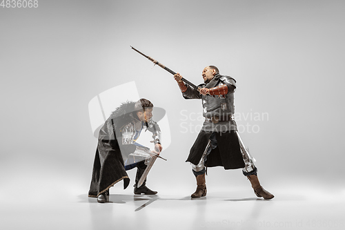 Image of Brave armored knights fighting isolated on white studio background