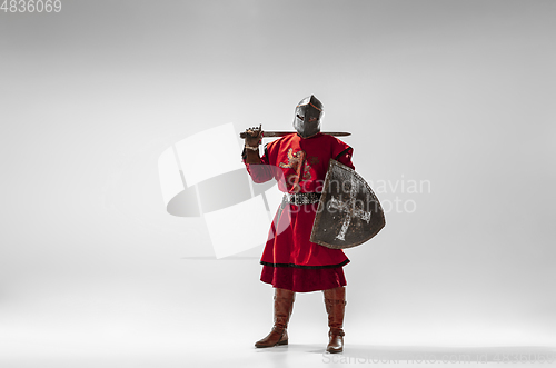 Image of Brave armored knight fighting isolated on white studio background