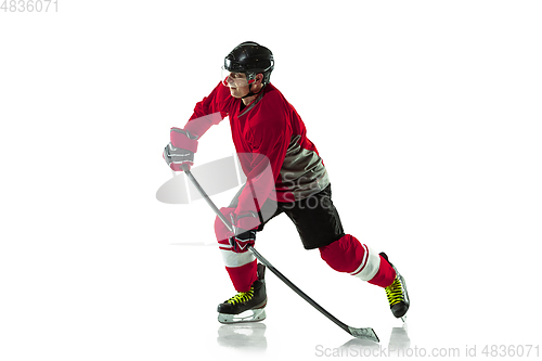 Image of Male hockey player with the stick on ice court and white background