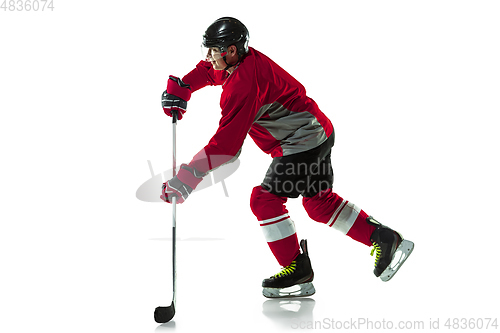 Image of Male hockey player with the stick on ice court and white background