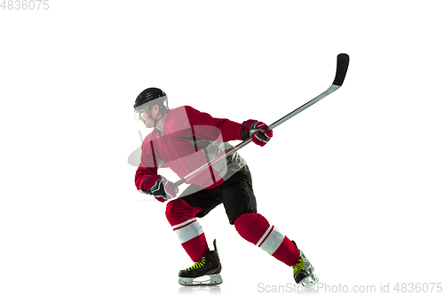 Image of Male hockey player with the stick on ice court and white background