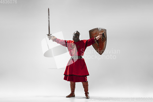 Image of Brave armored knight fighting isolated on white studio background