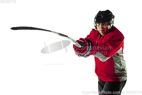 Image of Male hockey player with the stick on ice court and white background