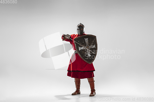 Image of Brave armored knight fighting isolated on white studio background