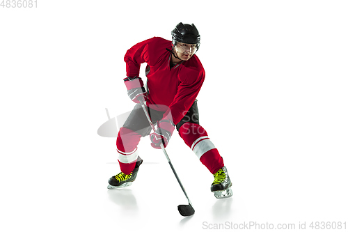 Image of Male hockey player with the stick on ice court and white background