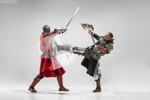 Image of Brave armored knights fighting isolated on white studio background