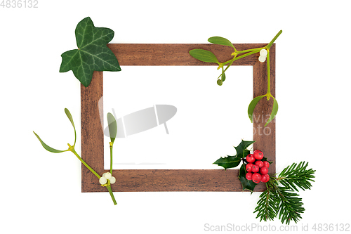 Image of Abstract Wooden Frame with Winter Greenery