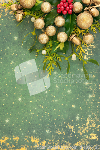 Image of Christmas Holiday Background with Gold Decorations and Flora