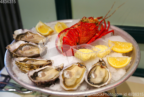 Image of Large dish with fresh seafood, oysters with lobster with lemon a