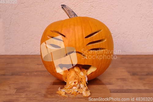 Image of Halloween funny pumpkin on wooden table 