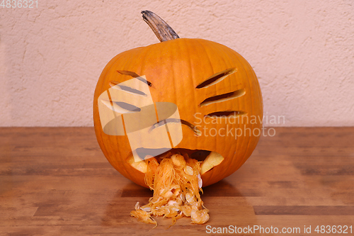 Image of Halloween funny pumpkin on wooden table 