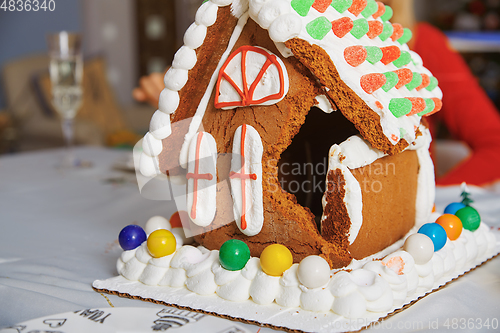 Image of Broken Gingerbread house on the table in Christmas decorated roo