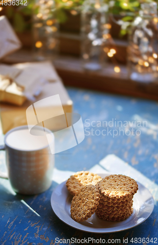 Image of Teacup and Christmas gluten free cookies on a table near the dec