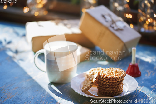 Image of Teacup and Christmas gluten free cookies on a table near the dec