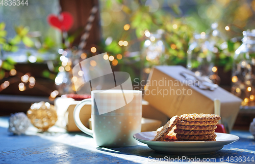 Image of Teacup and Christmas gluten free cookies on a table near the dec