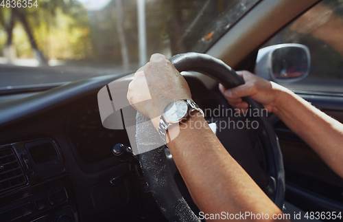 Image of Senior 65-70 years man driving car