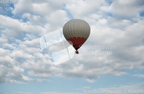 Image of One hot air balloon flying in the sky