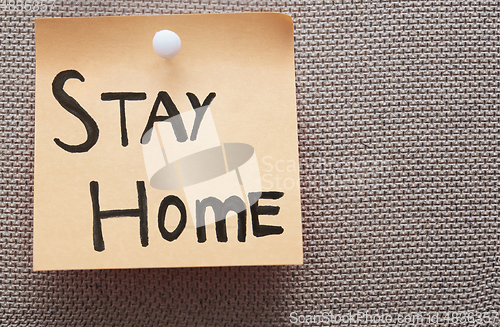 Image of Adhesive note with Stay Home text on a bulletin board