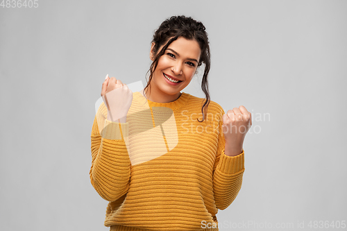 Image of happy young woman celebrating success