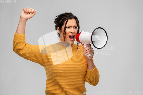 Image of angry young woman speaking to megaphone