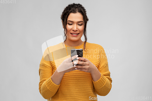 Image of happy woman using smartphone