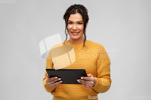 Image of happy young woman using tablet pc computer