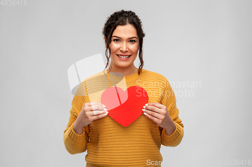 Image of happy smiling young woman with red heart