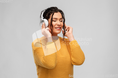 Image of happy woman in headphones listening to music